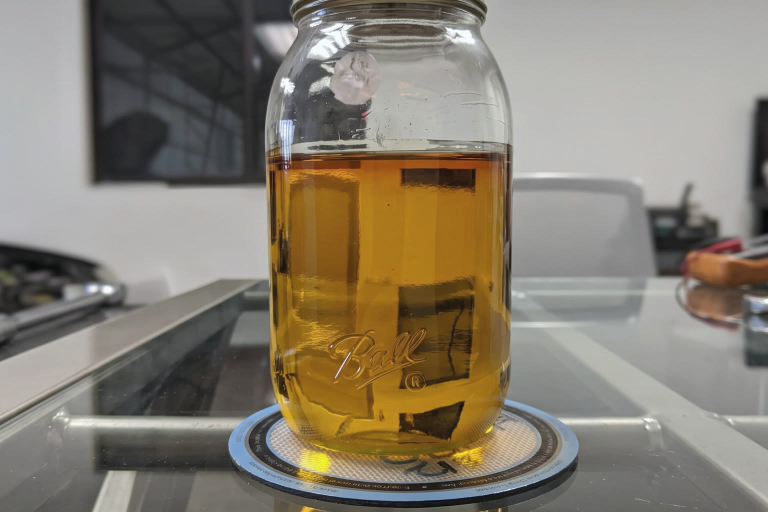 Mason jar of amber cannabinoid concentrate on a lab bench